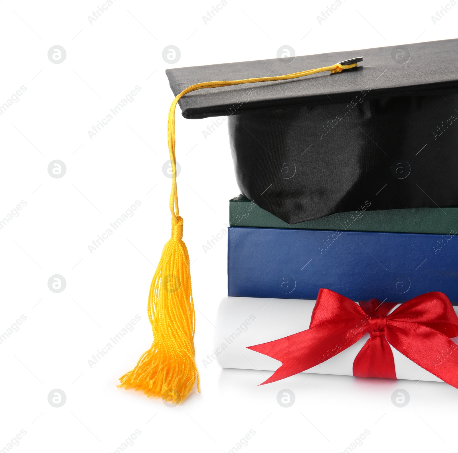 Photo of Graduation hat with books and diploma isolated on white