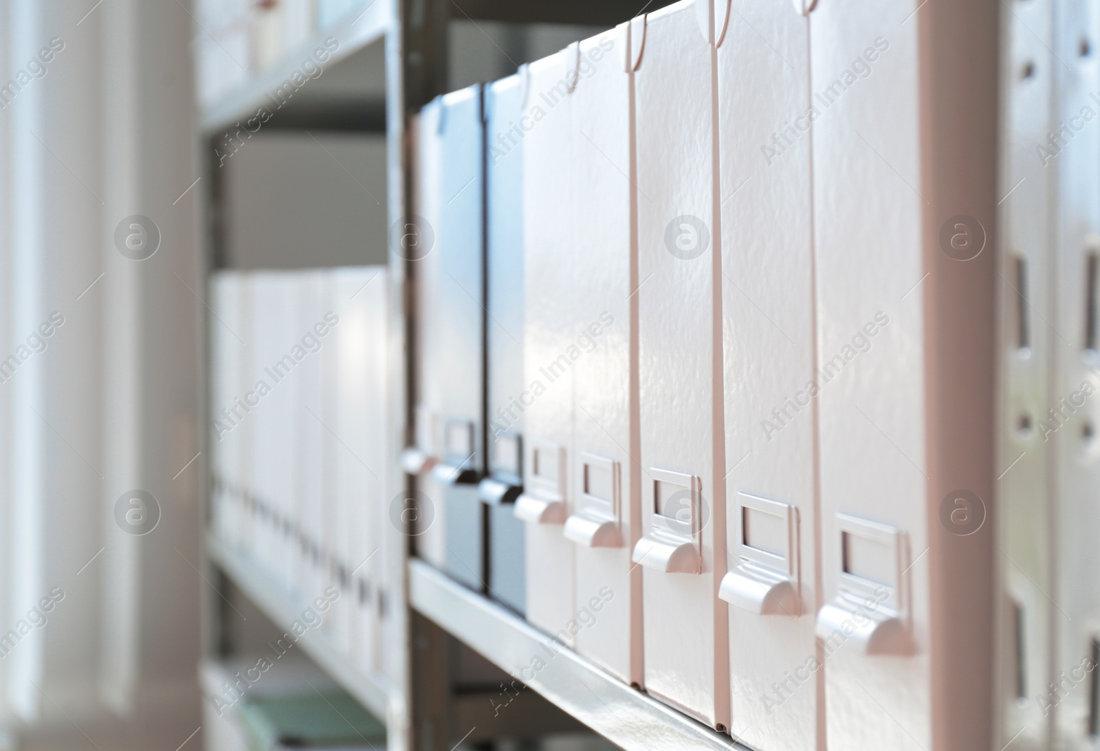 Photo of Folders with documents on shelf in archive