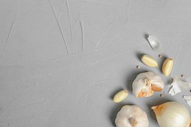 Photo of Flat lay composition with garlic, onion and space for text on table