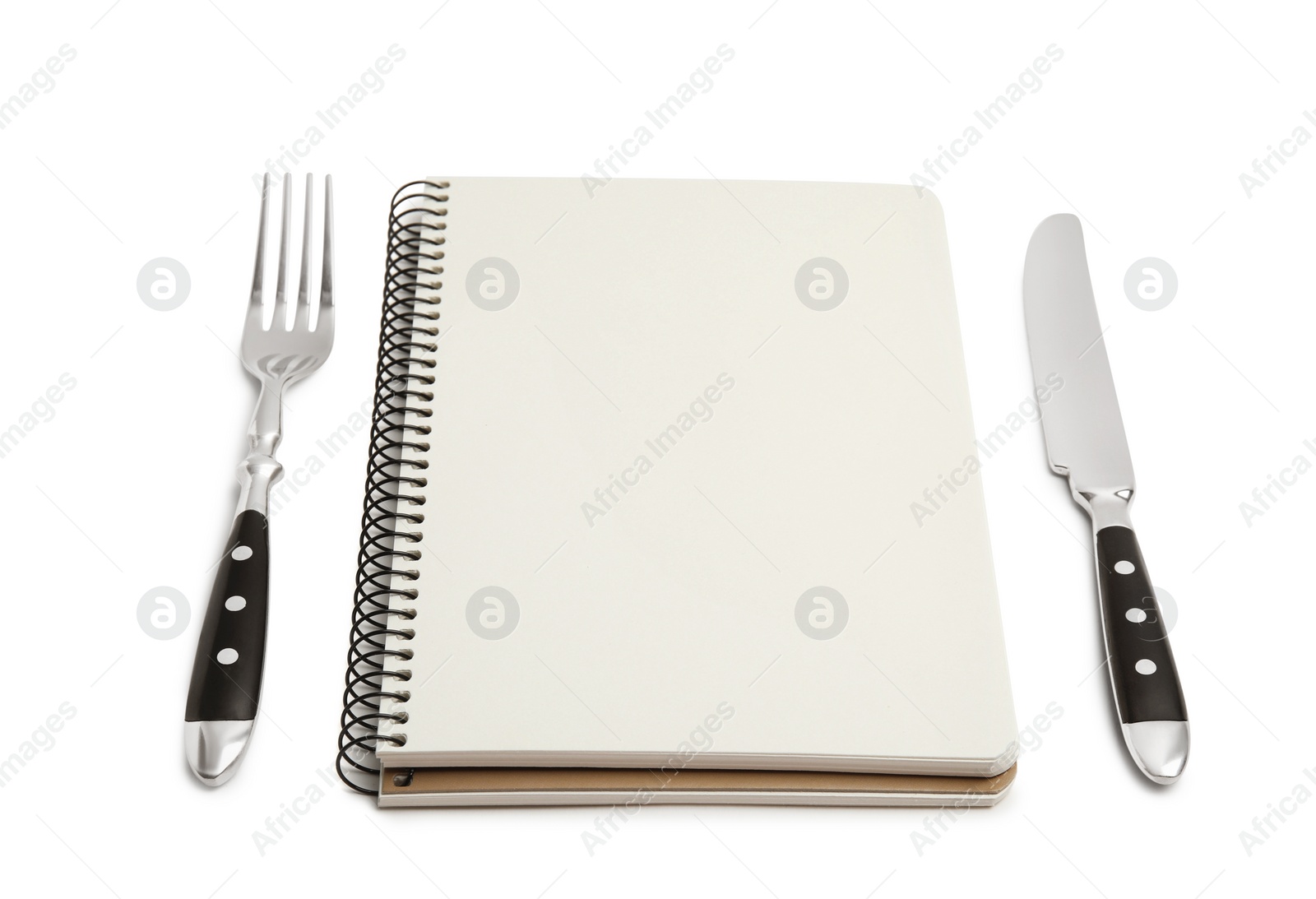 Photo of Blank recipe book and cutlery on white background. Space for text