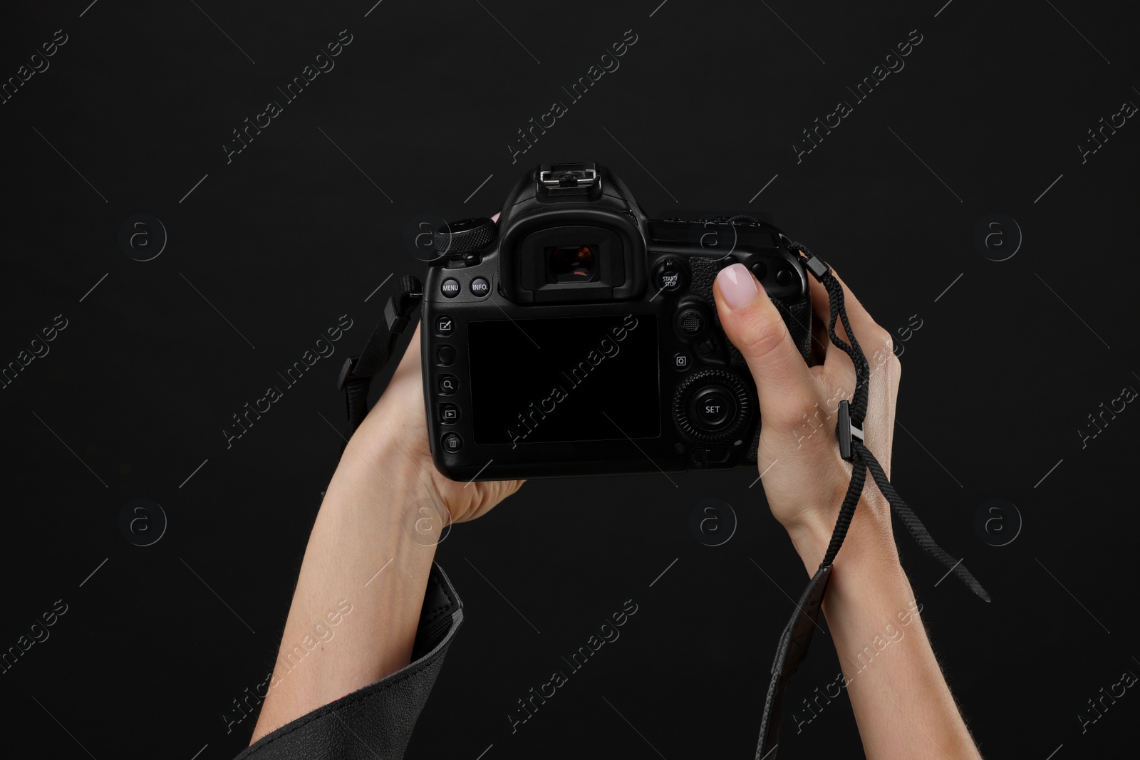 Photo of Photographer with camera on black background, closeup