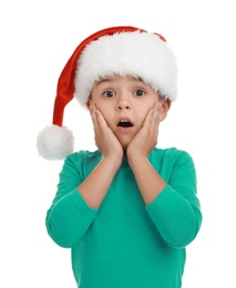 Photo of Emotional little child wearing Santa hat on white background. Christmas holiday