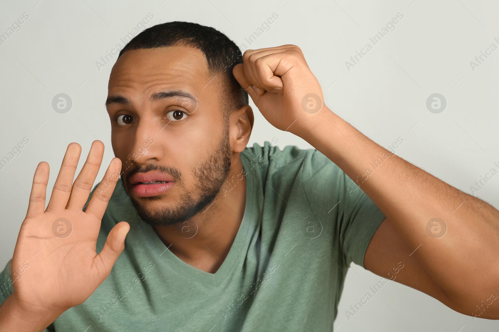 Photo of Young man stuck to transparent screen. Internet addiction concept