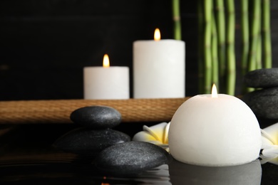 Photo of Spa composition with burning candle in water, space for text