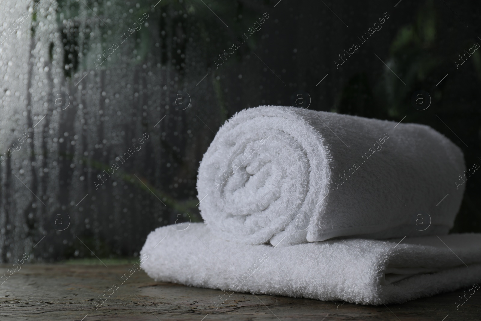 Photo of White terry towels on table in bathroom, space for text