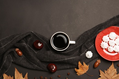 Photo of Flat lay composition with hot cozy drink and autumn leaves on dark background. Space for text