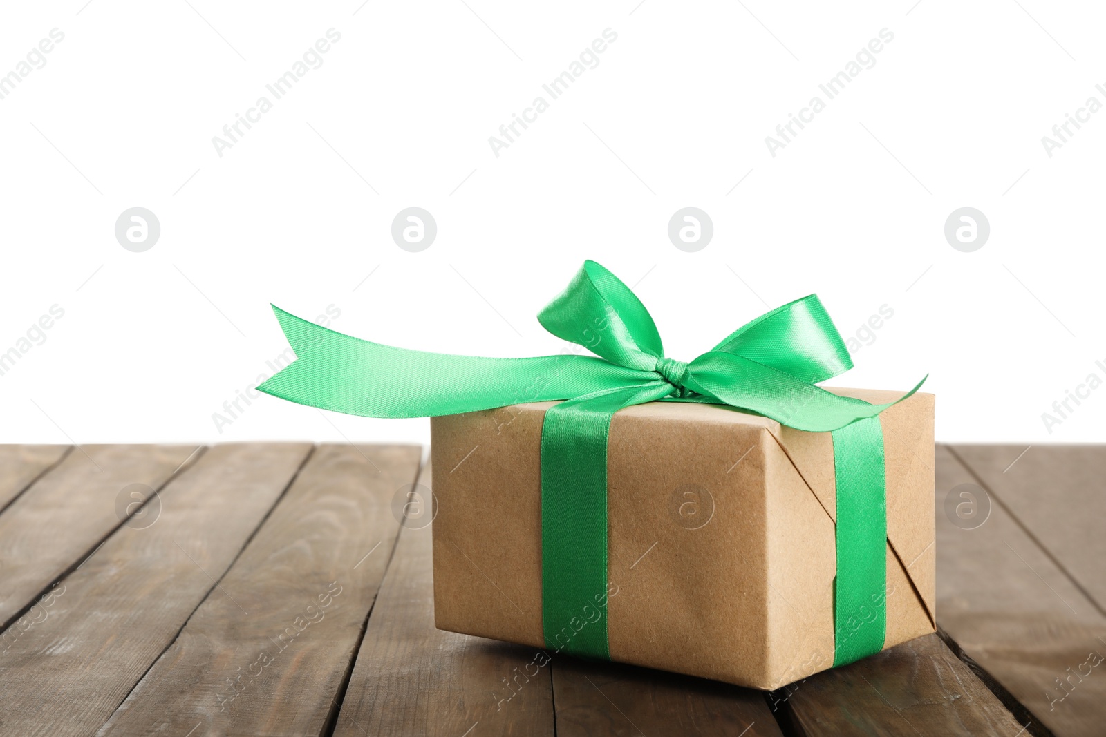 Photo of Christmas gift on wooden table against white background