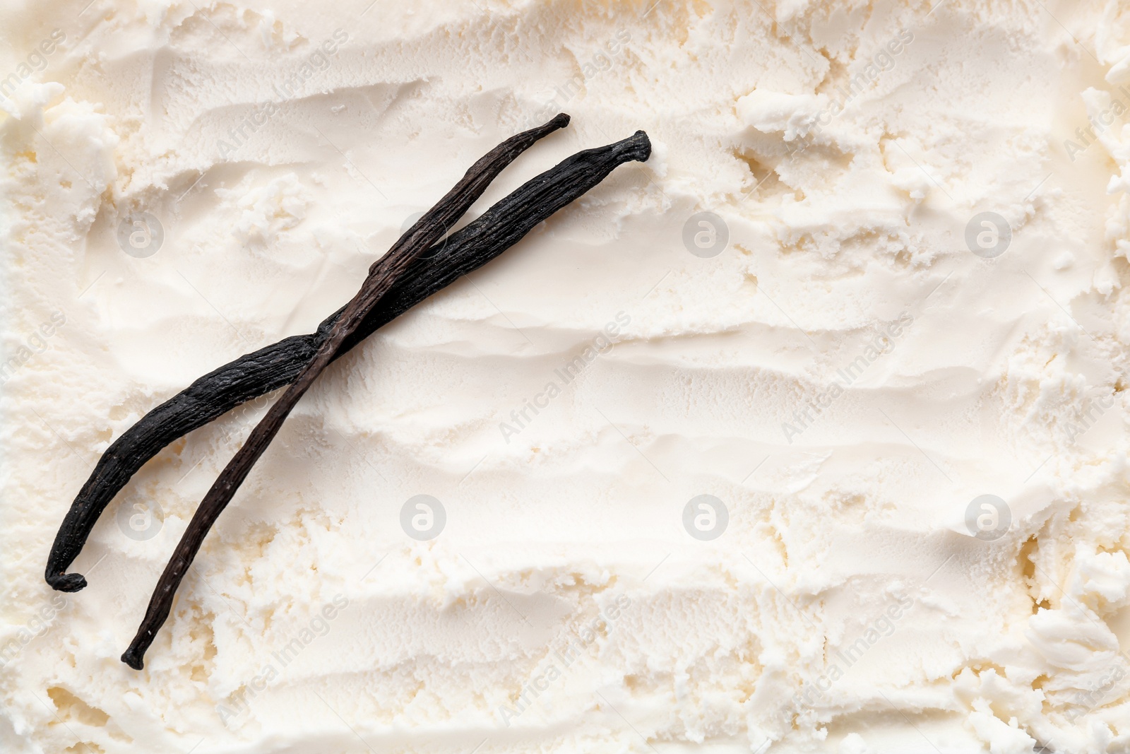 Photo of Tasty vanilla ice cream and sticks, closeup