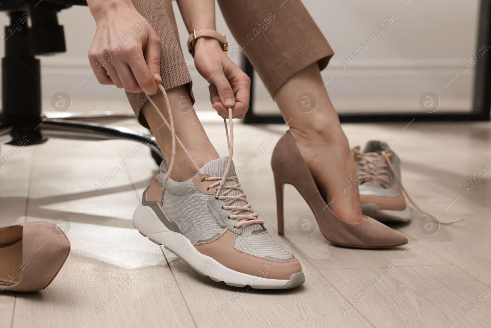 Photo of Woman changing shoes in office, closeup view