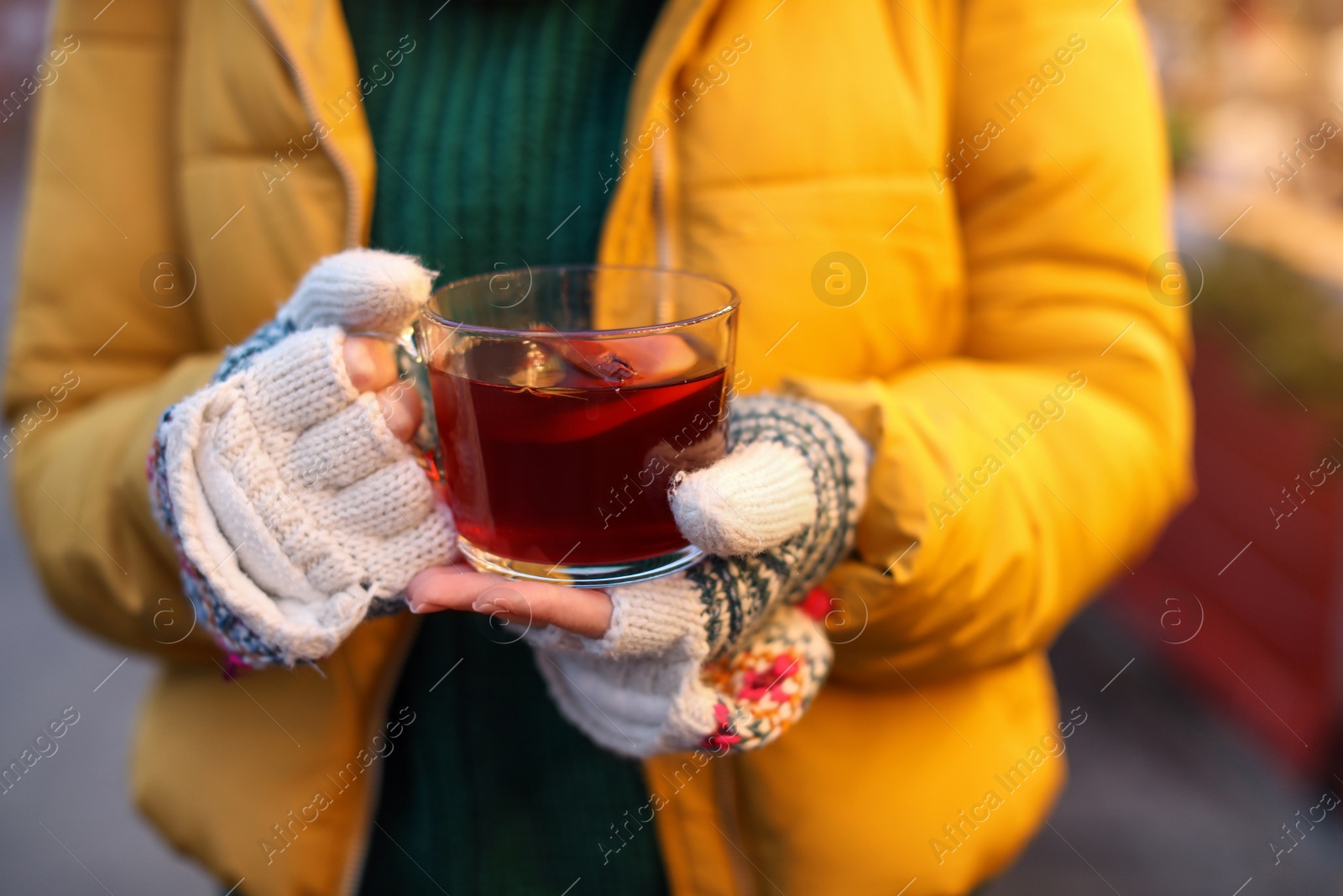 Photo of Woman with mulled wine at winter fair, closeup