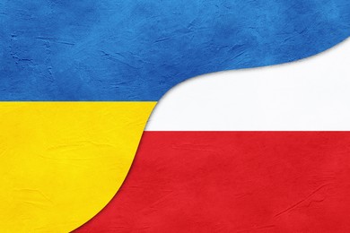 Flags of Ukraine and Poland on textured background. International diplomatic relationships