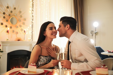 Happy couple having romantic dinner on Valentine's day in restaurant