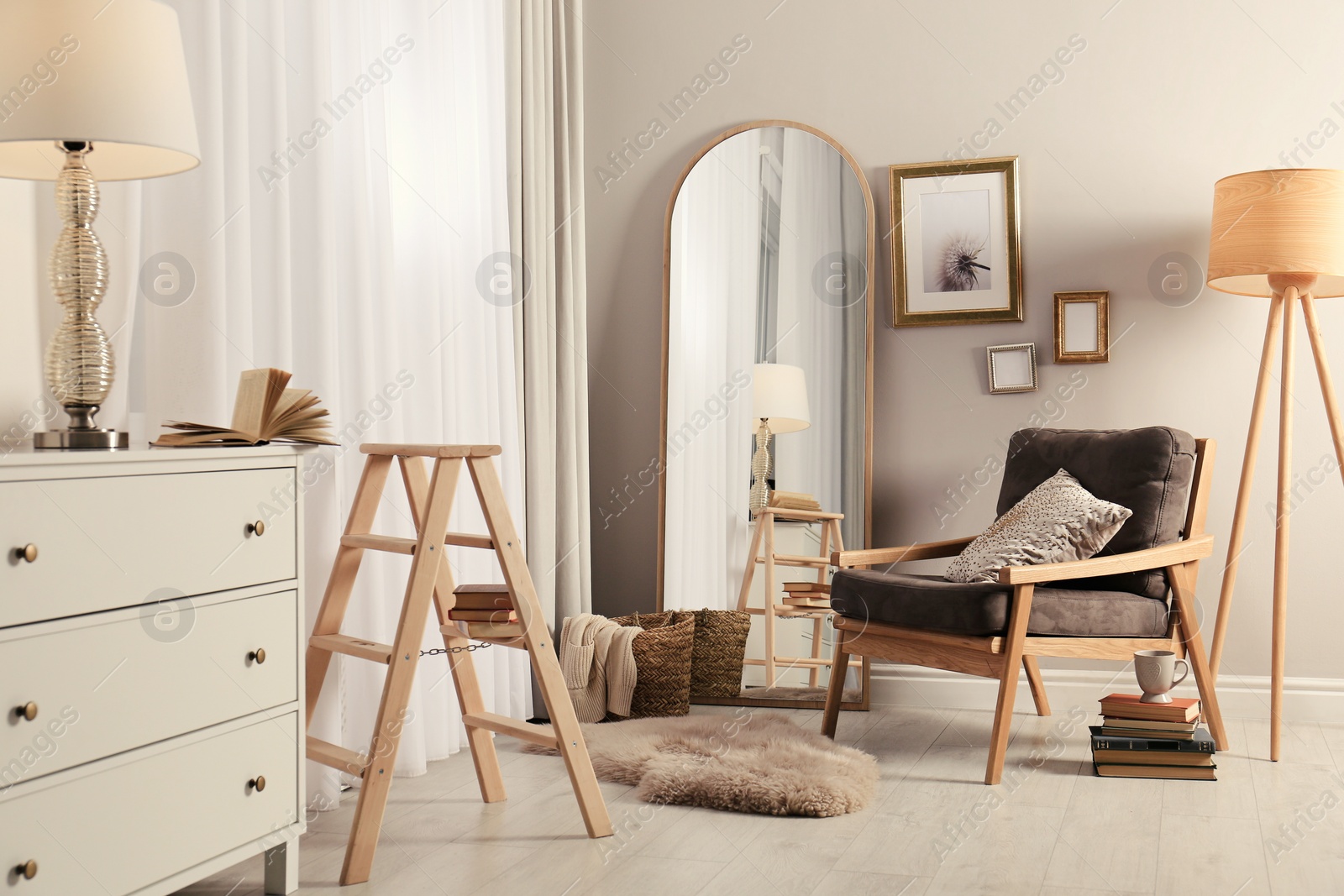Photo of Stylish room interior with large mirror and comfortable armchair