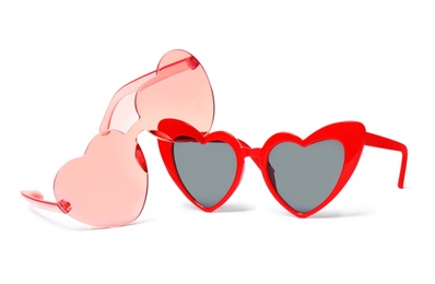 Photo of Different stylish heart shaped glasses on white background