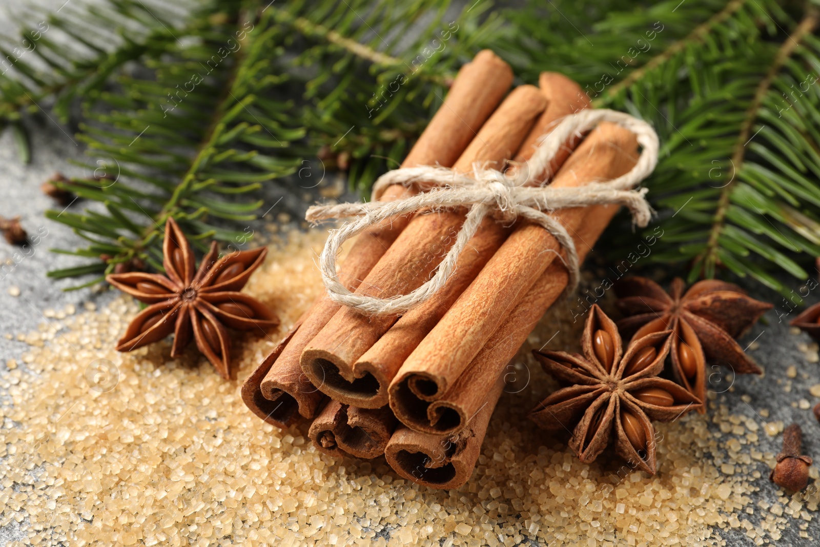 Photo of Different spices and fir branches on table, closeup