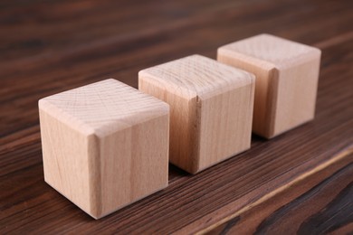 Photo of Cubes with abbreviation ISO on wooden table, closeup