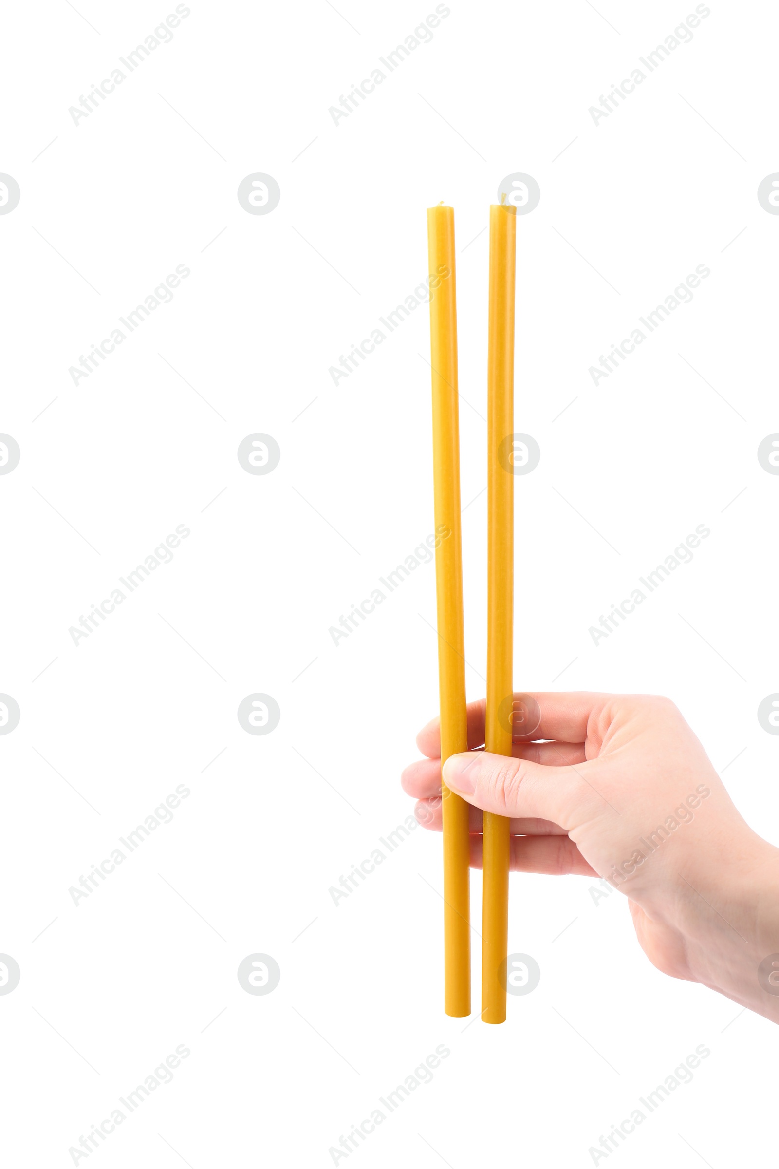 Photo of Woman holding church candles on white background, closeup