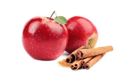 Image of Aromatic cinnamon sticks and red apples isolated on white