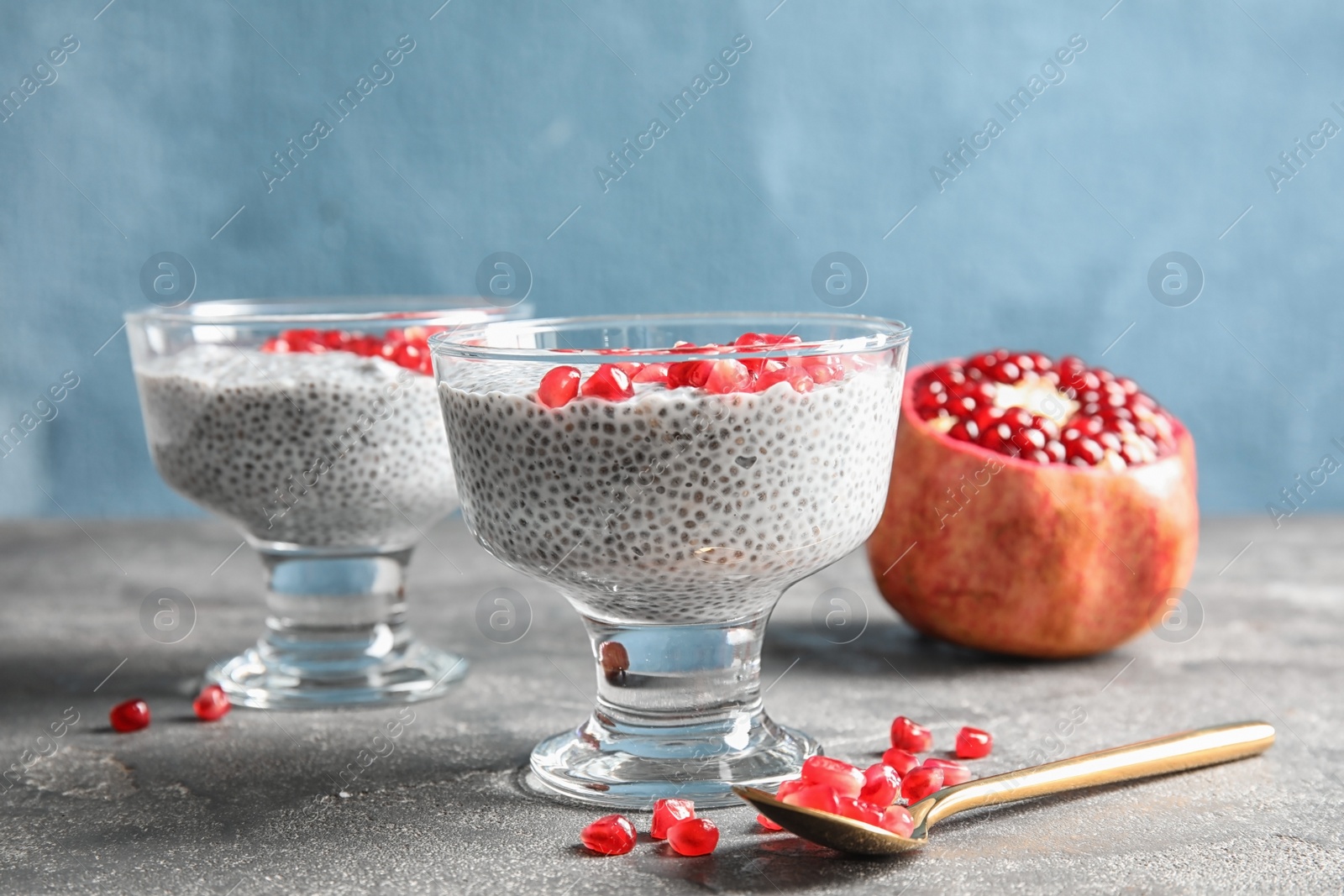 Photo of Tasty chia seed pudding with pomegranate on table
