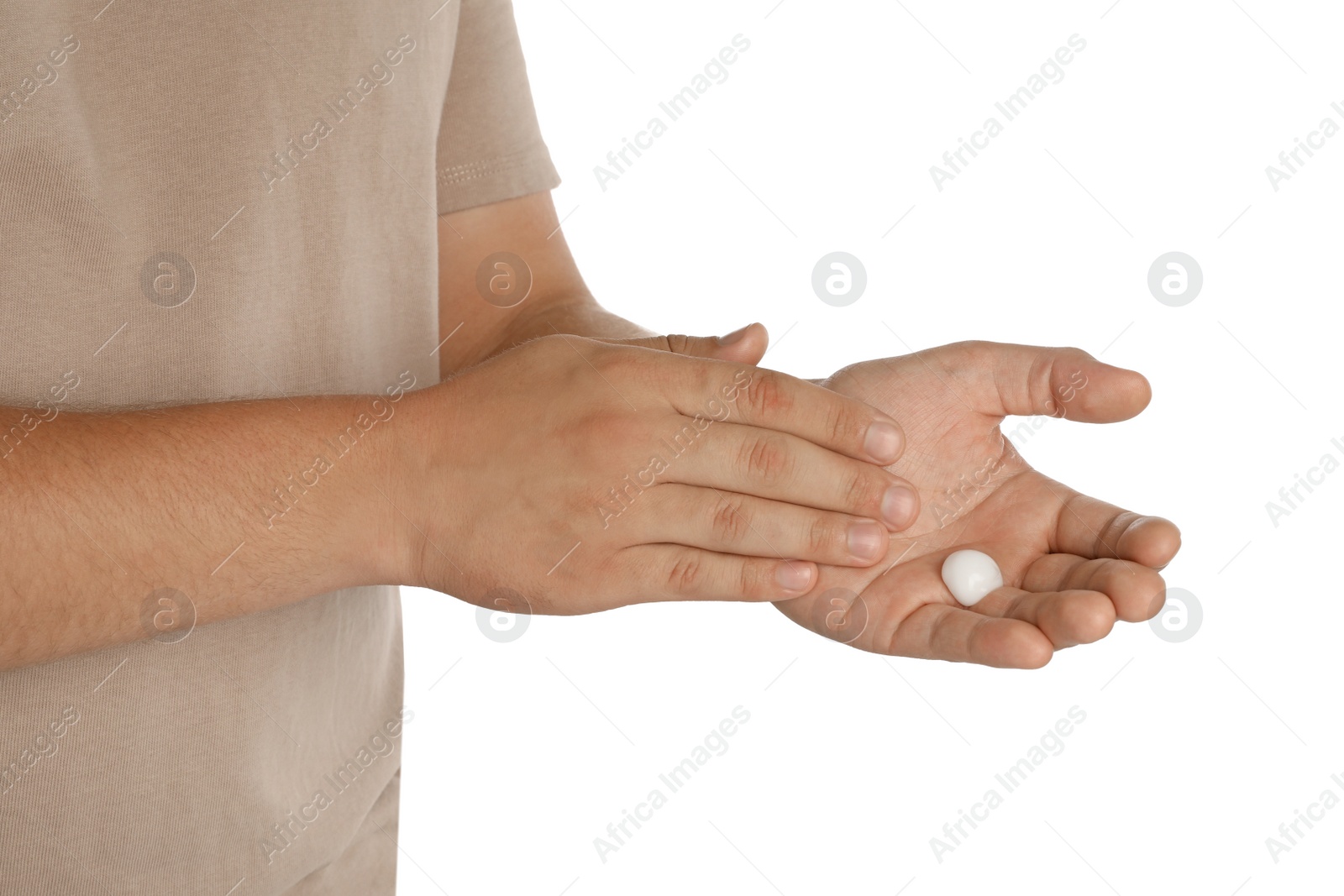 Photo of Man applying cream on hands against white background, closeup