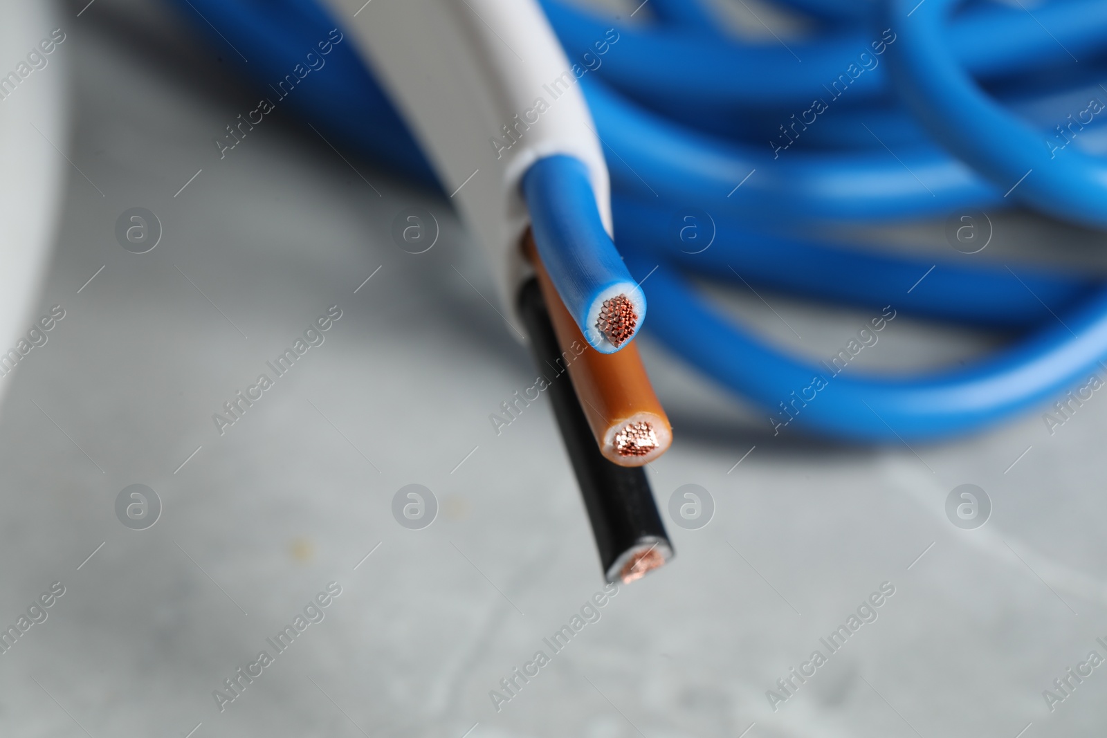 Photo of Colorful electrical wire on blurred background, closeup