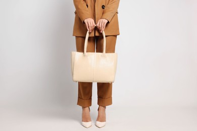 Photo of Young woman with stylish bag on white background, closeup