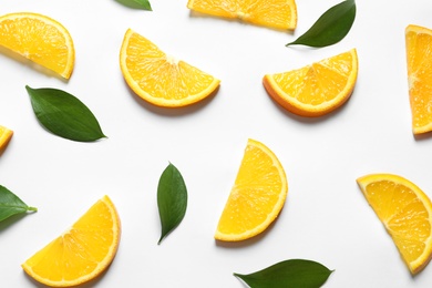 Composition with orange slices on white background, top view