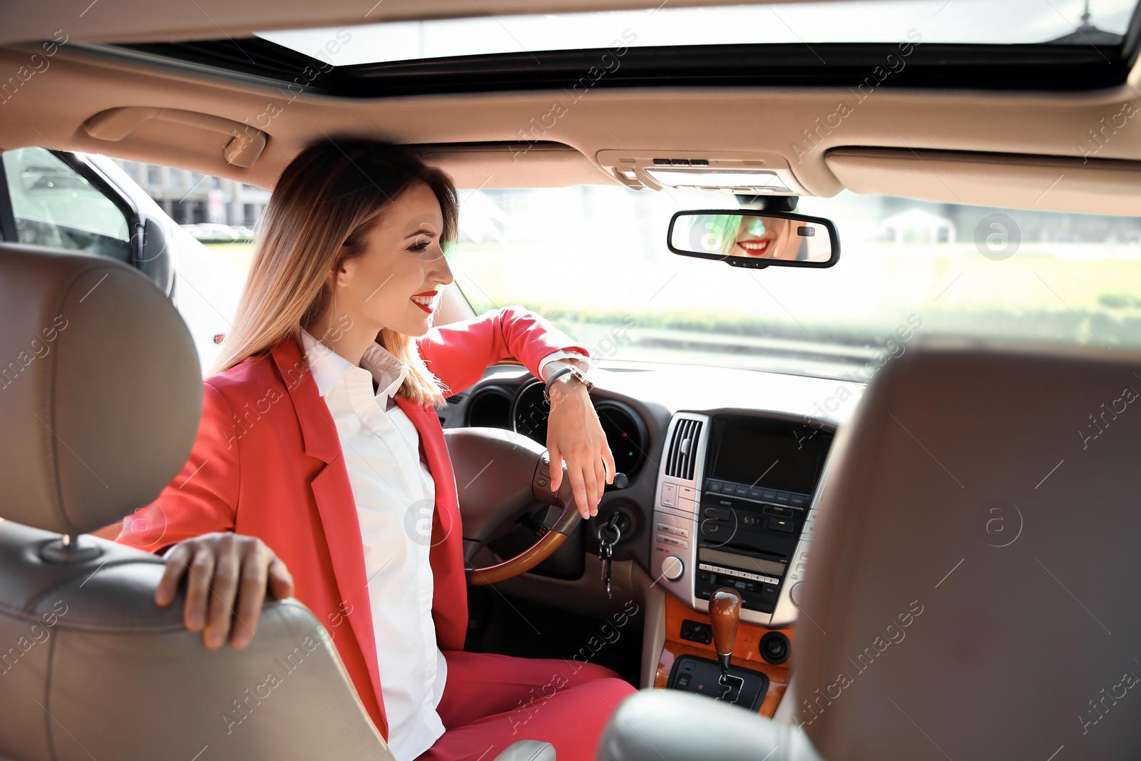 Photo of Young businesswoman on driver's seat of car