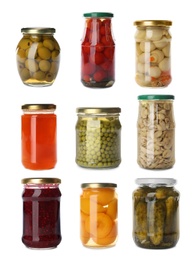 Set of jars with jams and pickled foods on white background