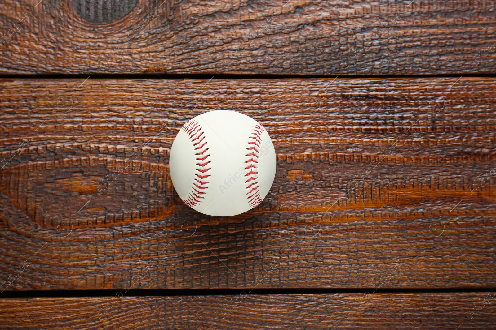 Photo of Baseball ball on wooden table, top view with space for text. Sportive equipment