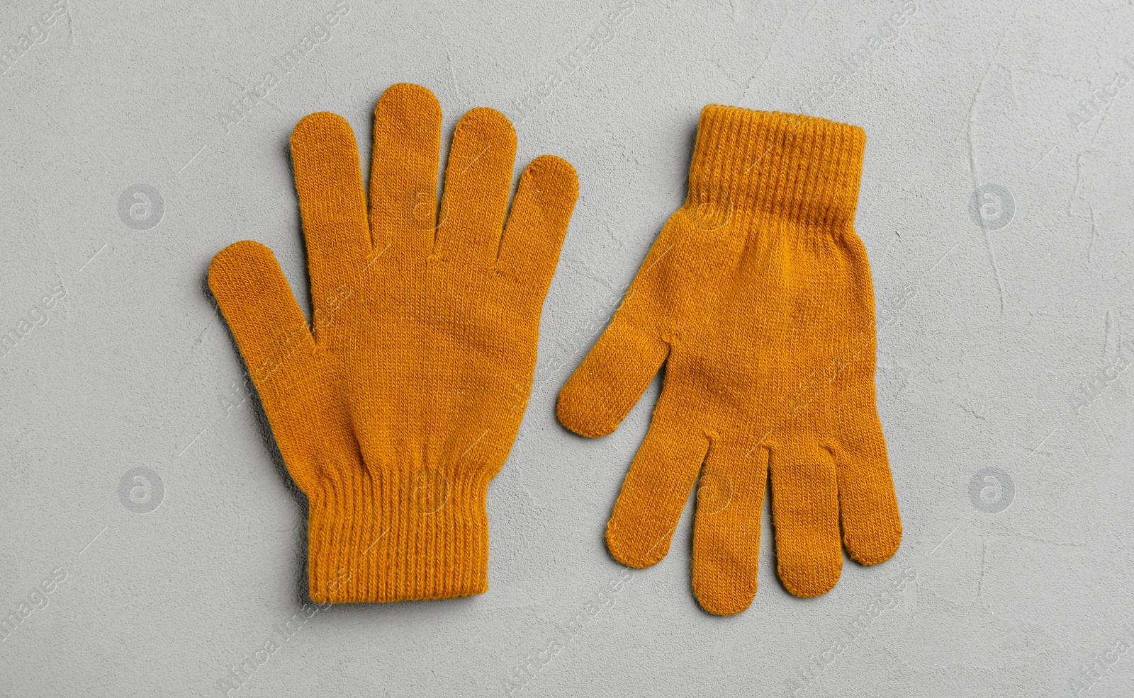 Photo of Stylish gloves on grey background, flat lay