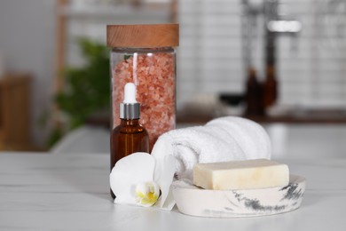 Photo of Composition with spa products and plumeria flower on white table indoors, closeup