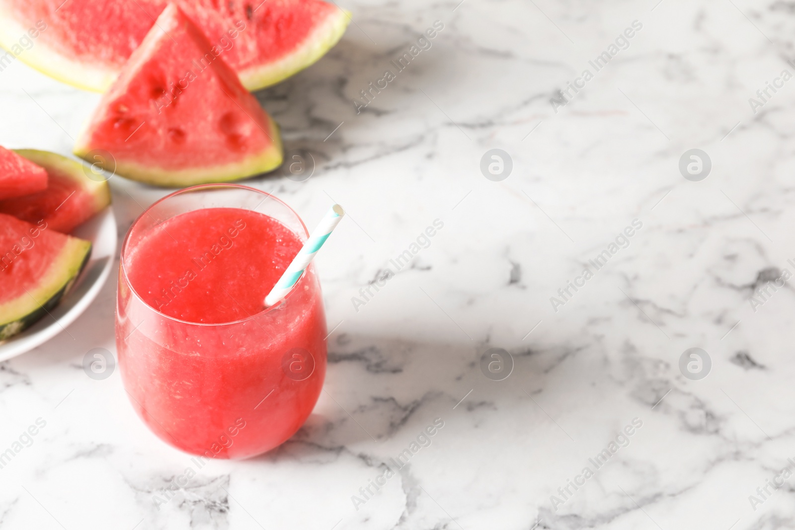 Photo of Tasty summer watermelon drink in glass on table. Space for text