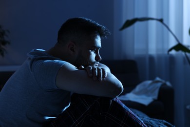 Photo of Frustrated man suffering from insomnia at night