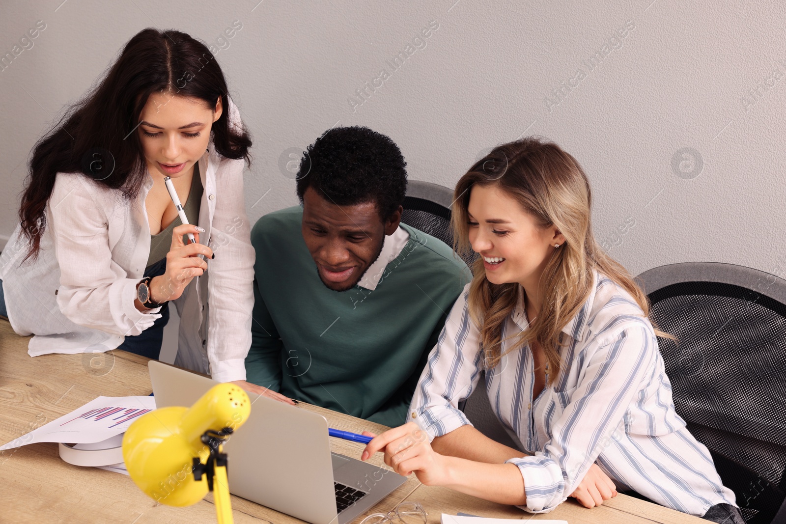 Photo of Team of employees working together in office. Startup project