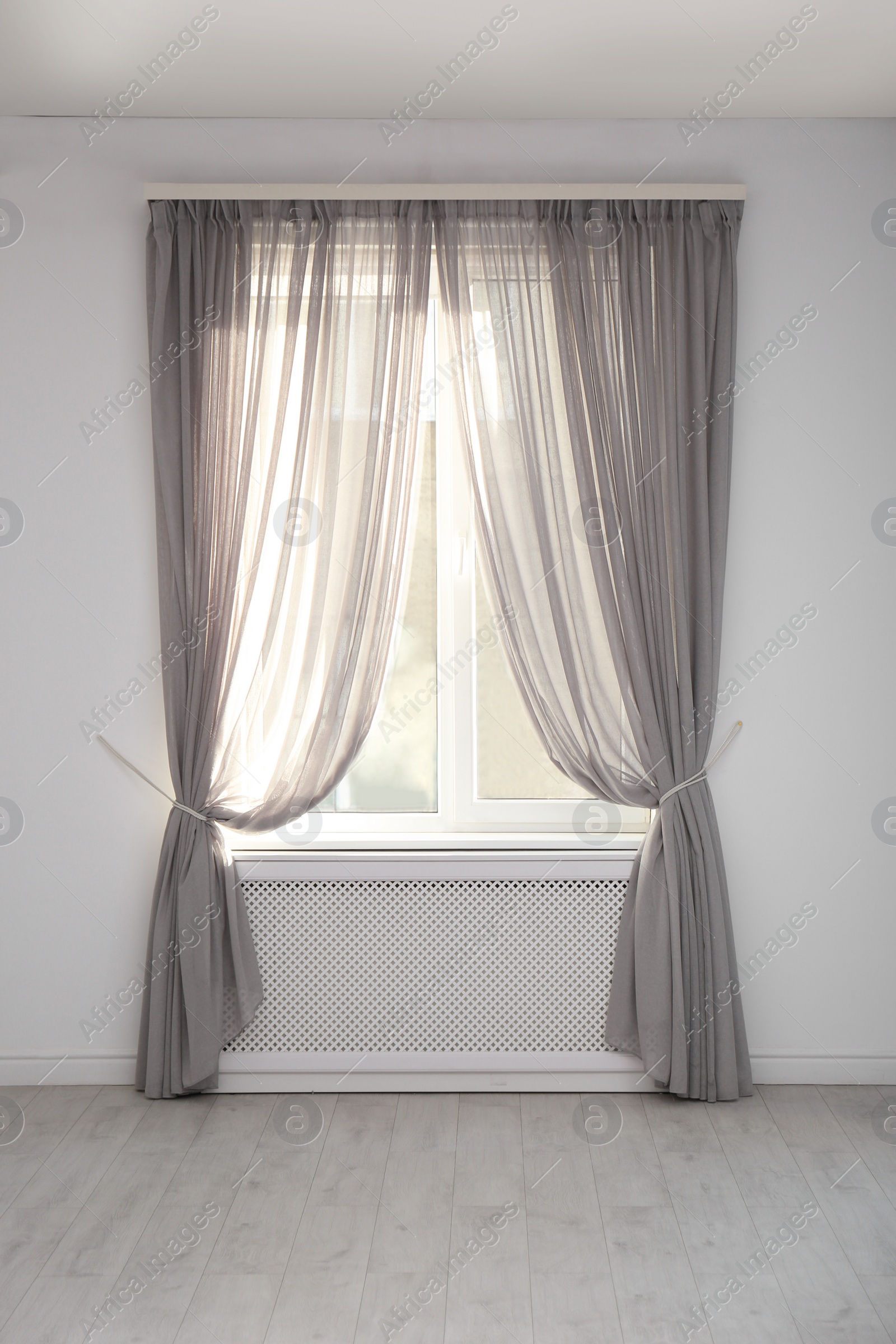 Photo of Window with beautiful curtains in empty room