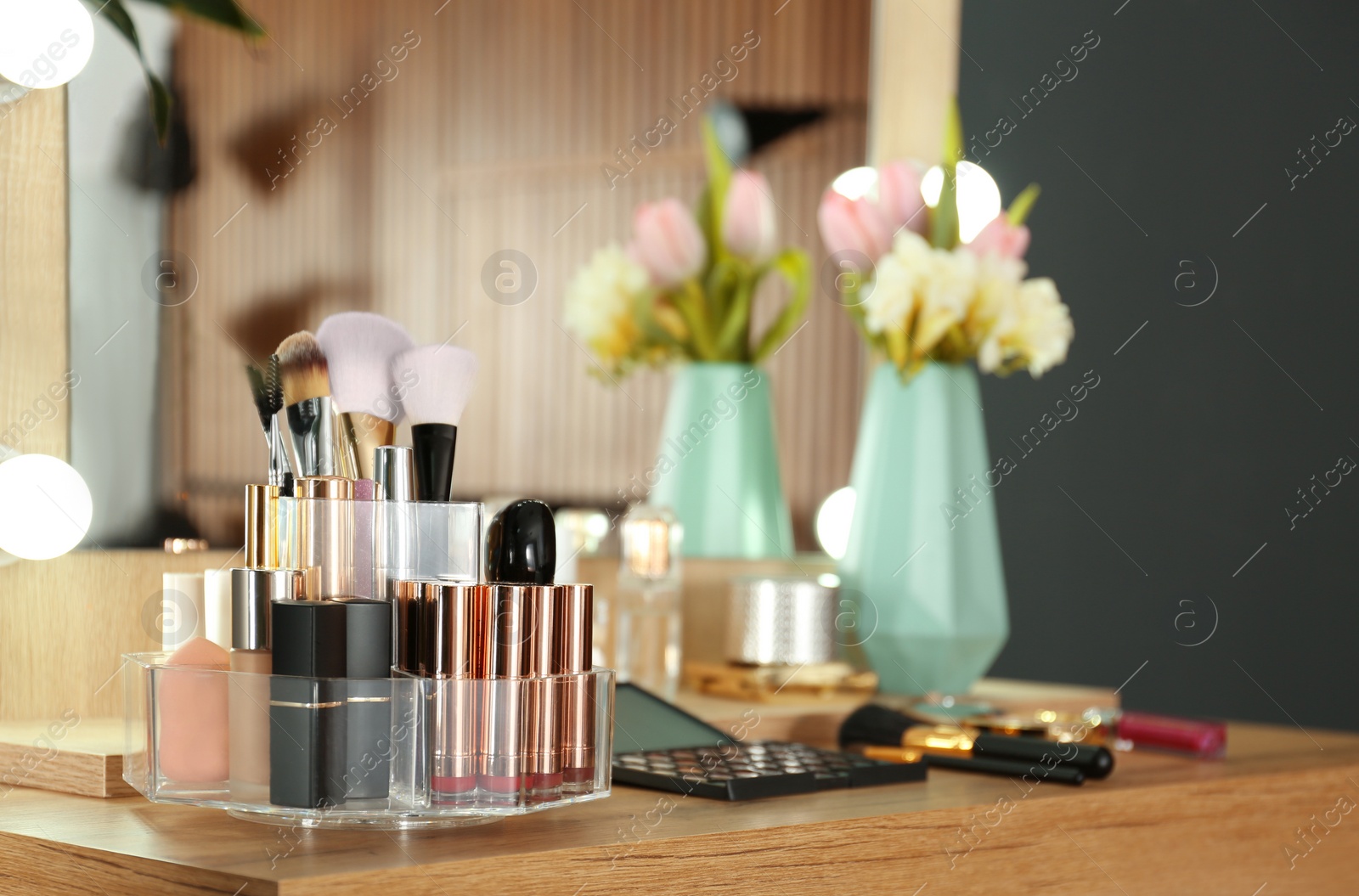 Photo of Dressing table with set of luxury cosmetic products. Interior element