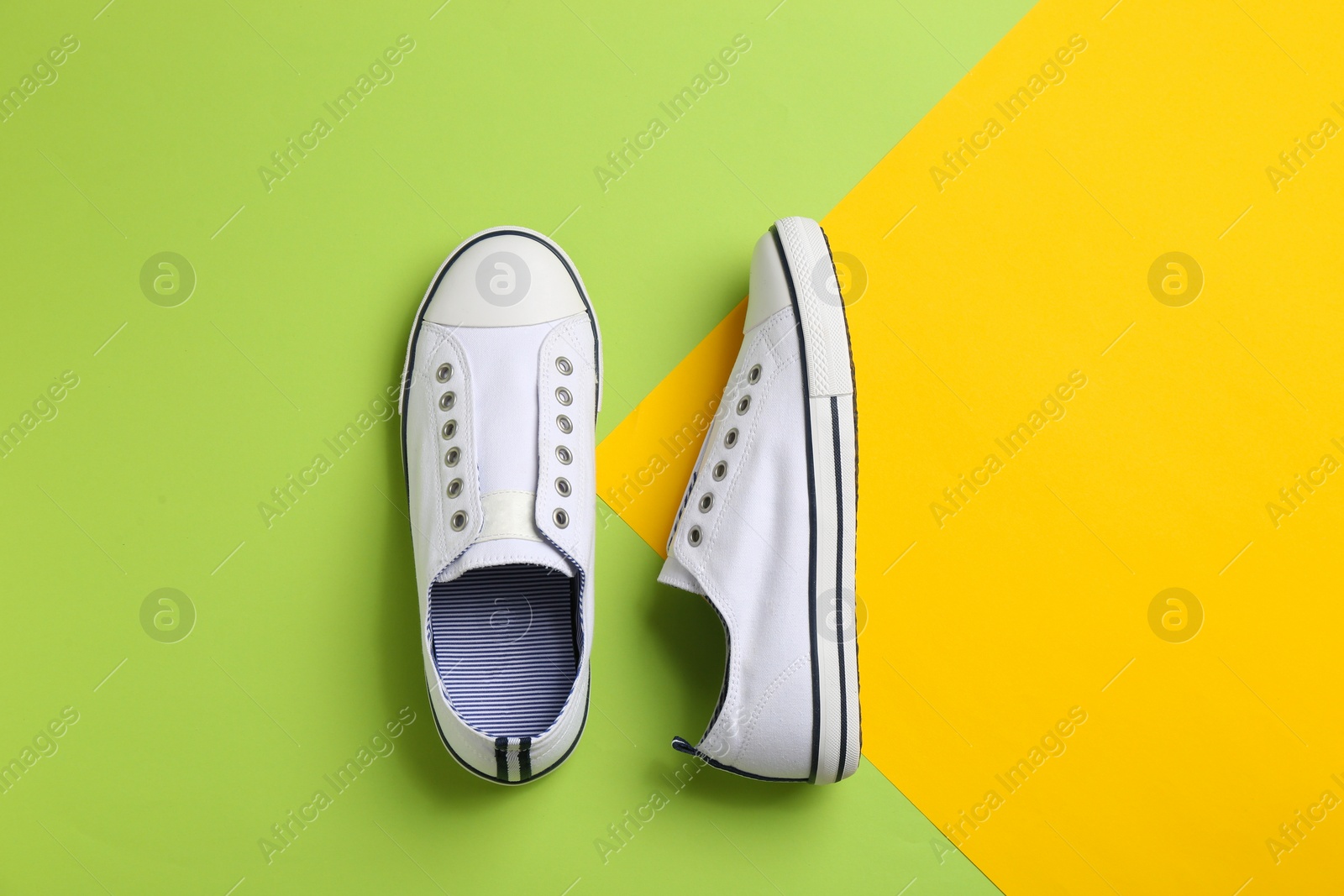 Photo of Pair of stylish sneakers on color background, flat lay