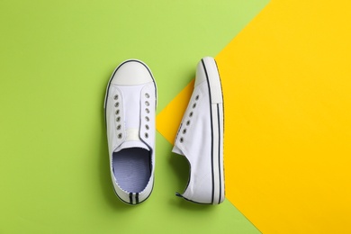 Pair of stylish sneakers on color background, flat lay