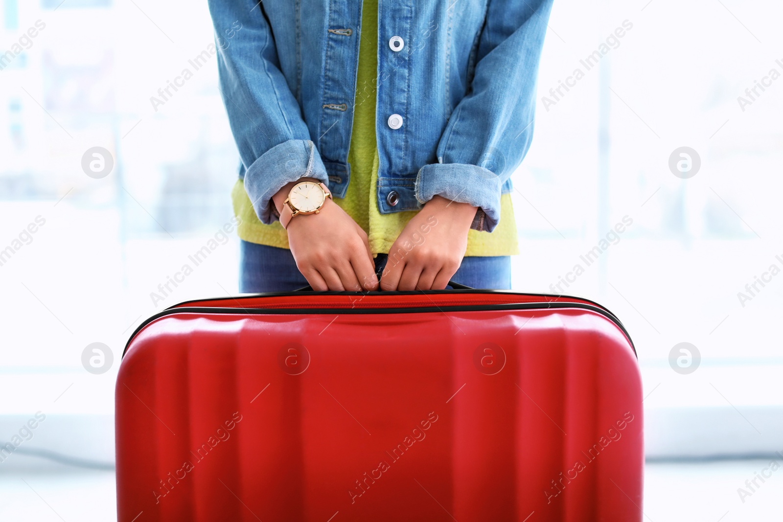 Photo of Young woman with suitcase indoors