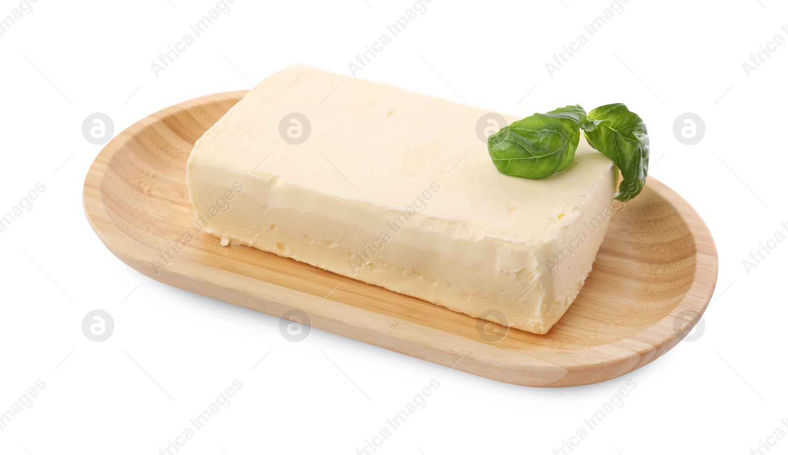 Photo of Block of tasty butter with basil isolated on white