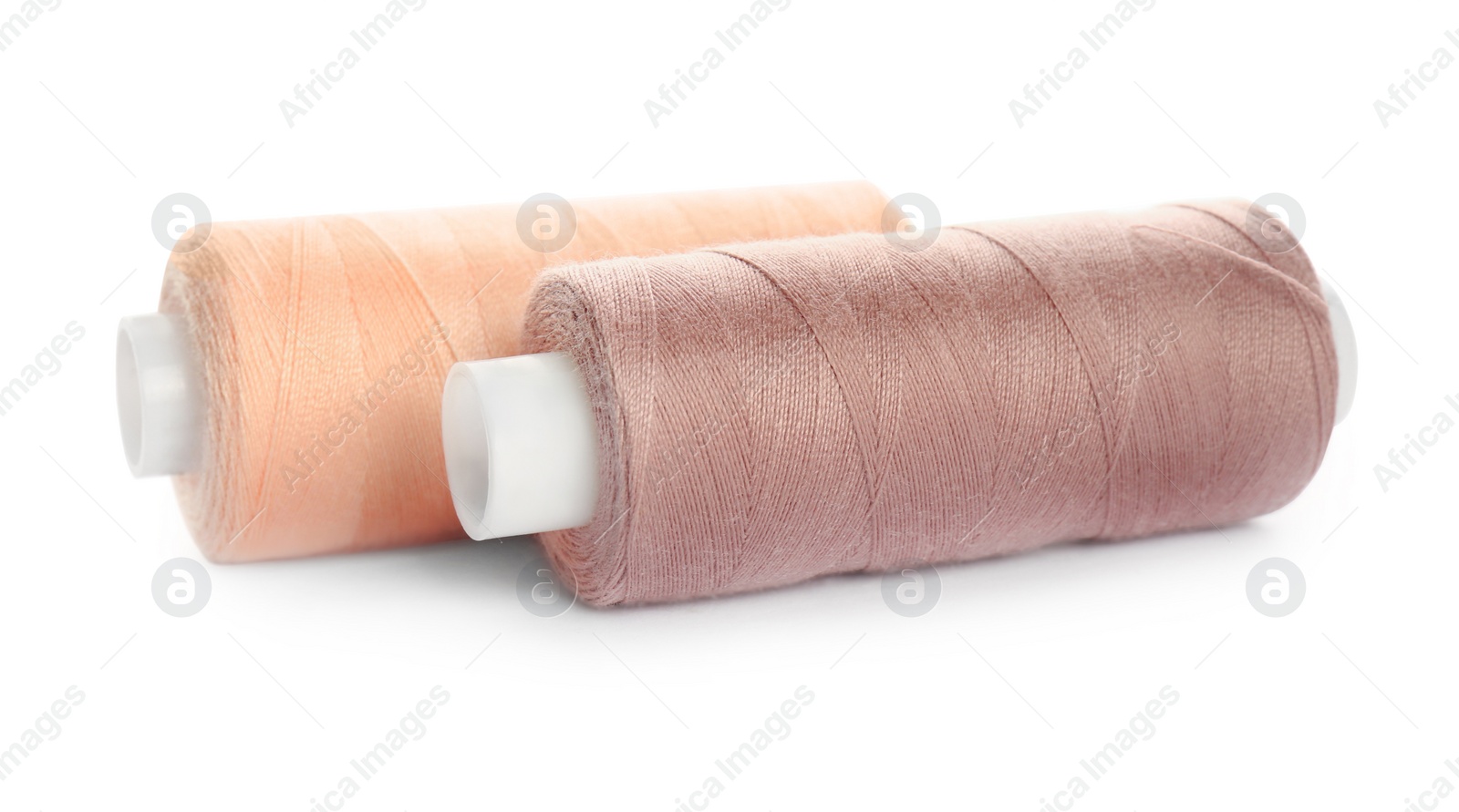 Photo of Different colorful sewing threads on white background