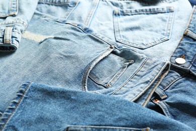 Photo of Variety of jeans with different pockets as background, closeup