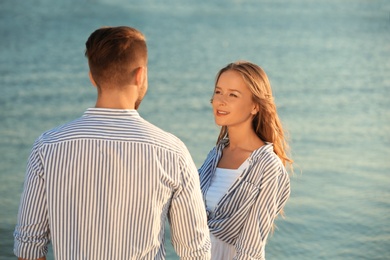 Happy young couple resting together on beach