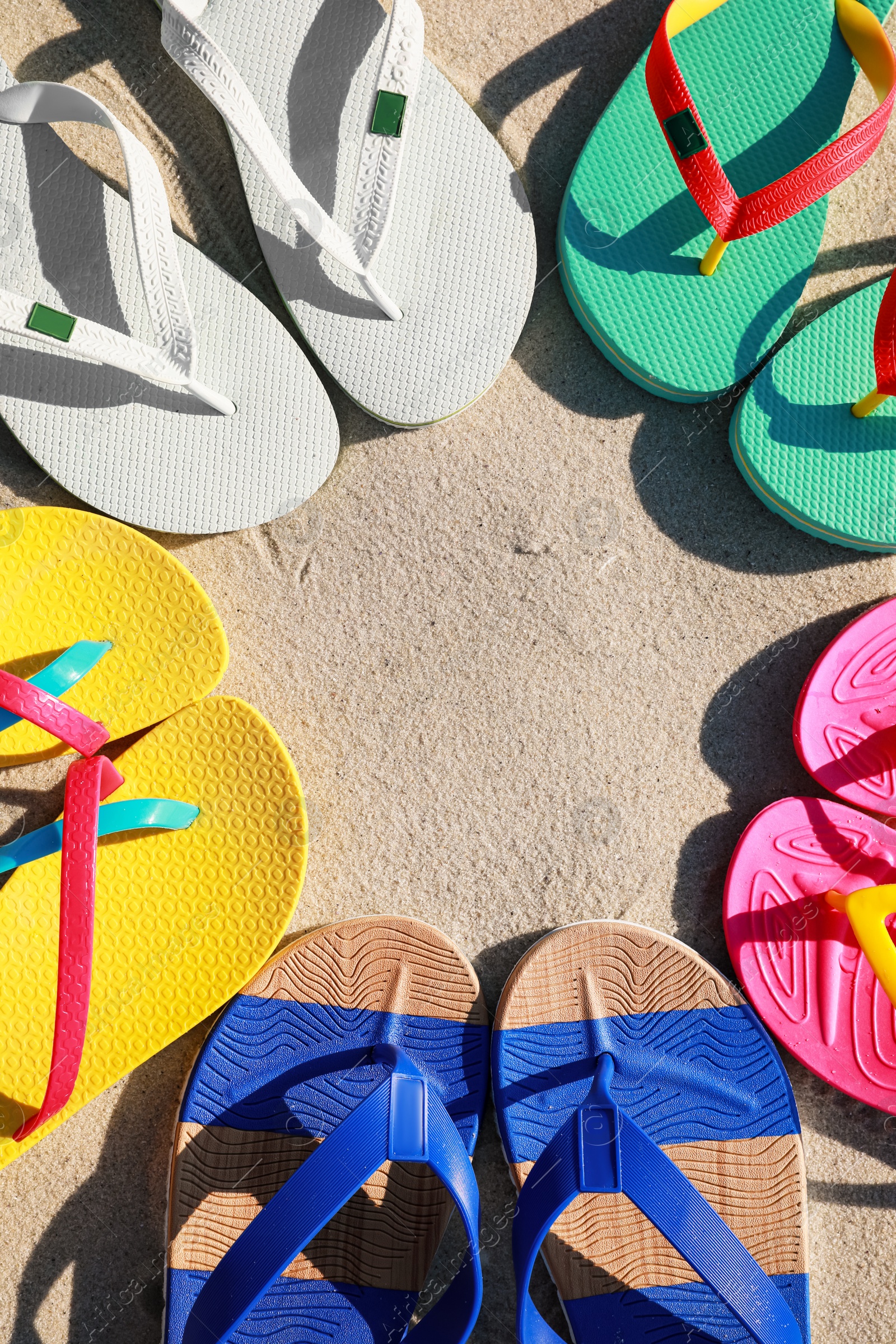 Photo of Stylish flip flops on beach, flat lay. Space for text