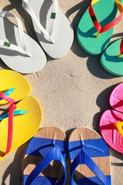 Stylish flip flops on beach, flat lay. Space for text