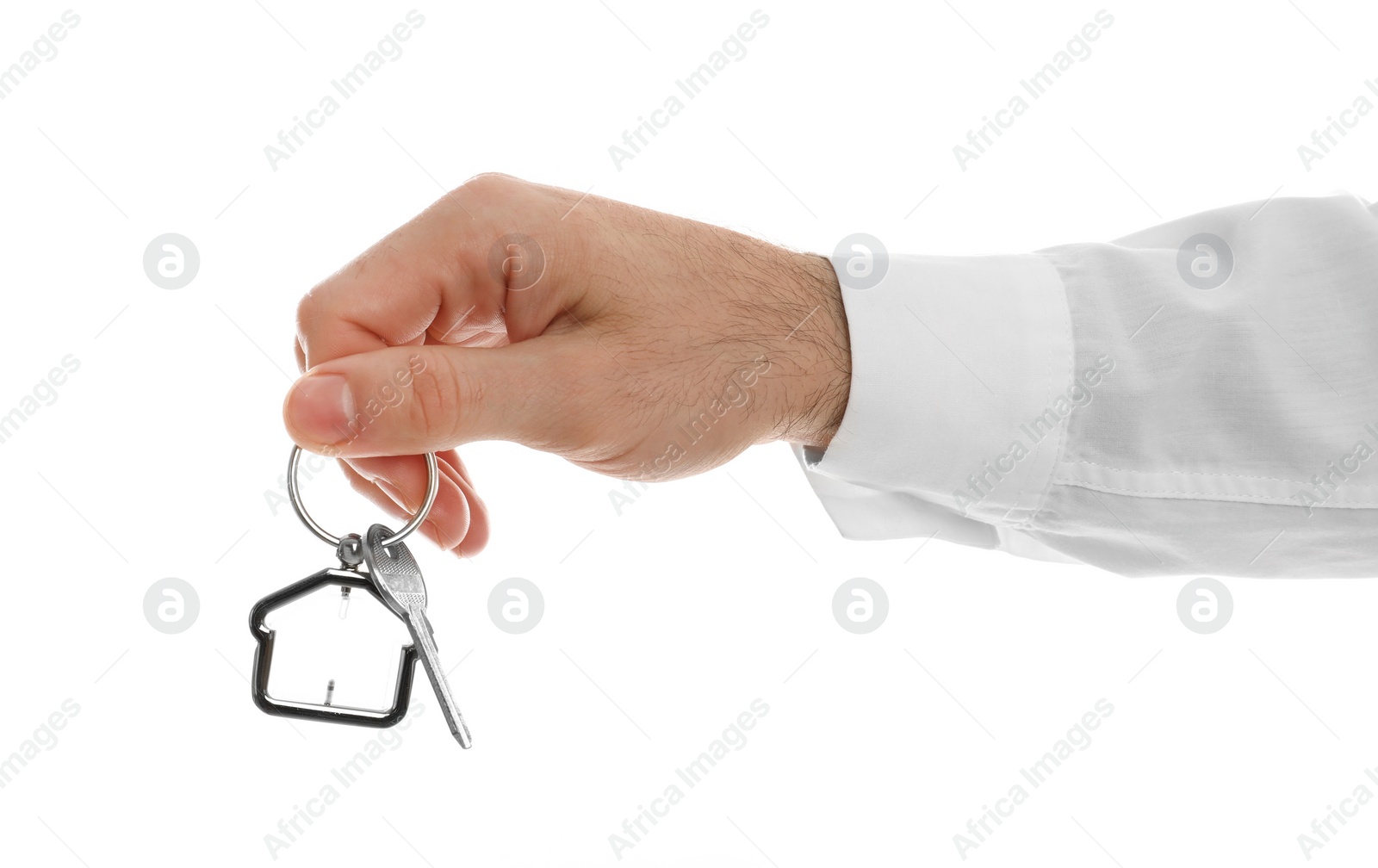 Photo of Real estate agent holding house key with trinket on white background, closeup