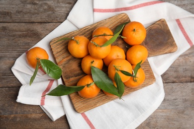 Flat lay composition with fresh ripe tangerines on wooden background