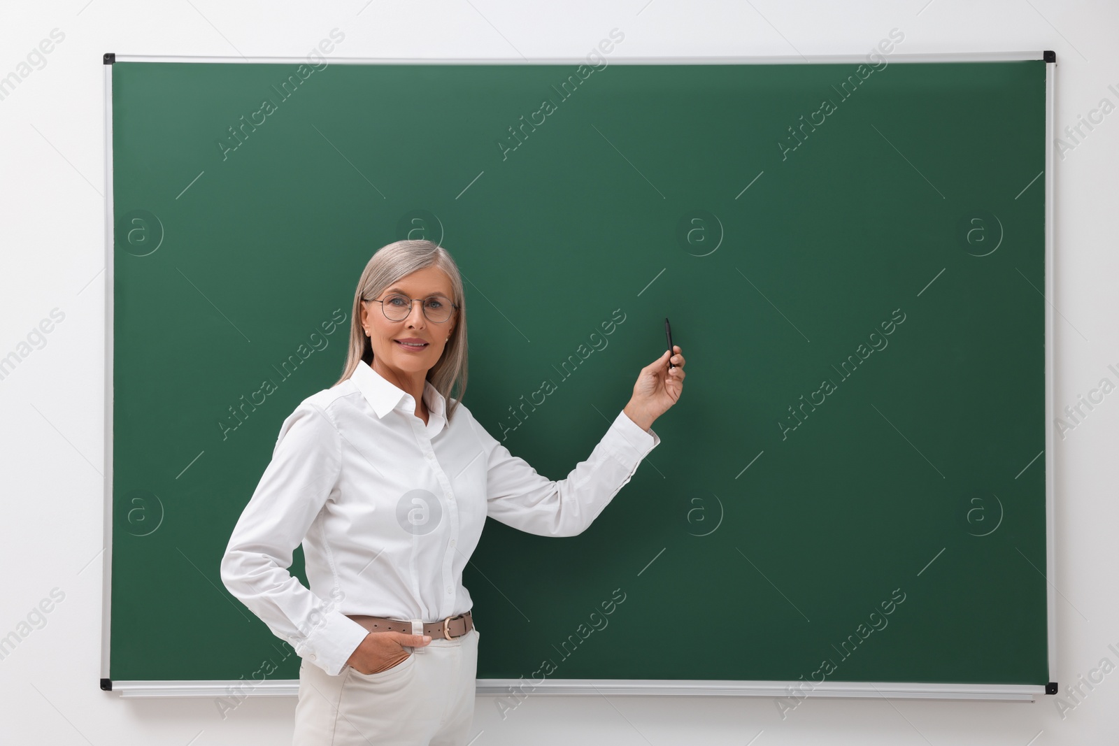 Photo of Professor explaining something at blackboard indoors, space for text