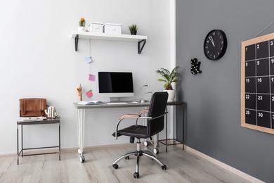 Comfortable workplace with computer on desk in home office